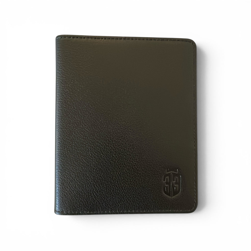 A black genuine textured leather timebook cover with a debossed shield logo in the bottom right corner, shown on a plain white background.